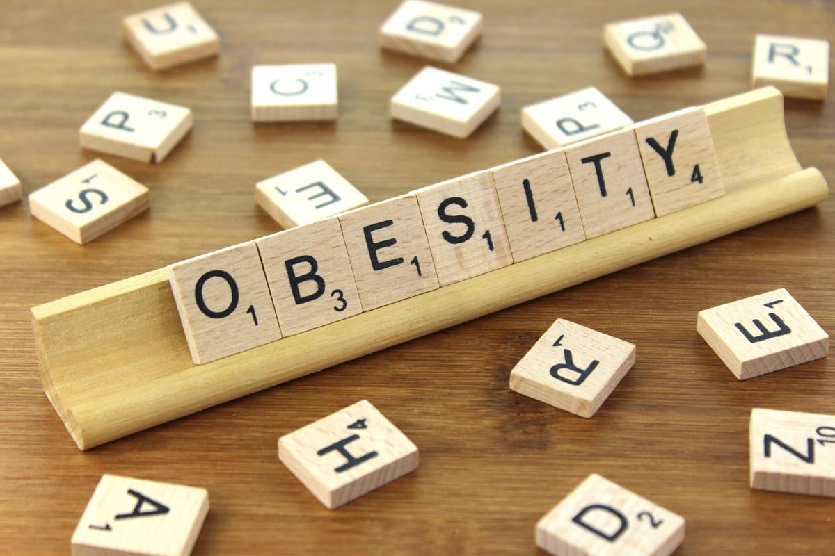 Scrabble tiles spelling out the word 'obesity'